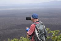 Man taking picture, Sierra Negra vulcano, Galapagos, Ecuador